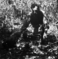 Miller squatting over the body of a jaguar