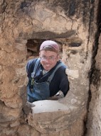 Dr. Steve Nash peers through a door at the Hinkle Park Cliff Dwelling research site.
