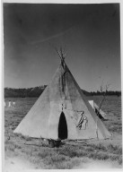 Camp scene: Tipi with tent behind.