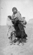 Portrait of a Ute boy and girl carrying a water jar