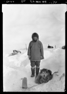 Eskimo man and sled dogs in Wainwright, Alaska