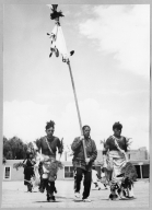 San Ildefonso Pueblo, Corn Dance. Adam Martinez (?), son of Maria Martinez, carrying clan banner