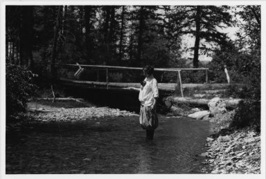 Unidentified woman fishing in mountain stream