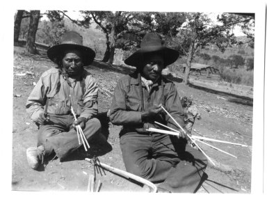 Jicarilla Apache men making bows and arrows