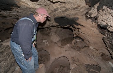 Dr.Steve Nash looks at the back wall at the Hinkle Park Cliff Dwelling site.