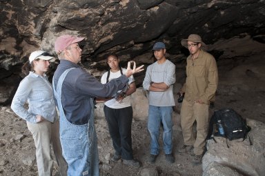 Dr. Steve Nash explains an object to the field team at the Hinkle Park Cliff Dwelling.