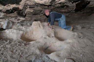 Dr. Steve Nash examines deep impressions at the Tularosa Cave.