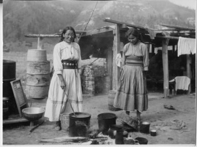 Jennie and her sister, Hazel Veneno, cooking outdoors.