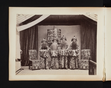 Group of four oriental men with false beards.
