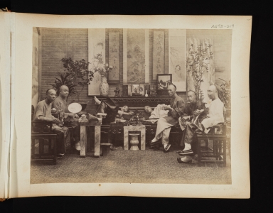 Group of seven men in an opium den in China.