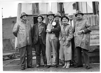 Australia Fieldwork- Alfred Bailey and Pat Witherspoon with miners in front of the Central Deborah Gold Mine