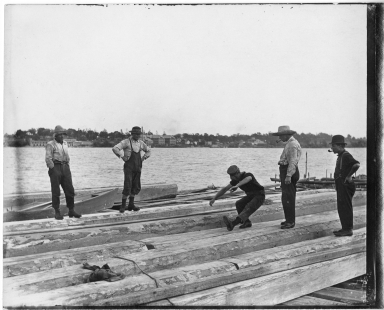 Men aboard a log raft
