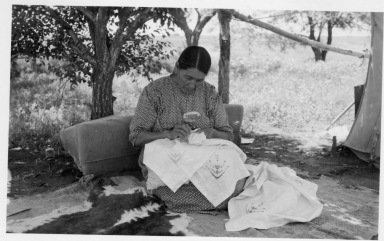 Sioux woman doing needlework